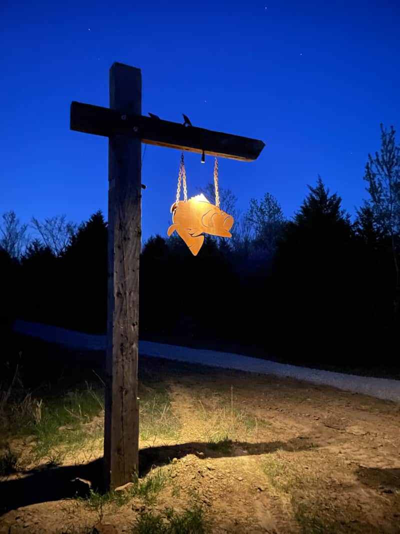 Illuminated Rusted Fish sign at RustedFish Ranch at twilight